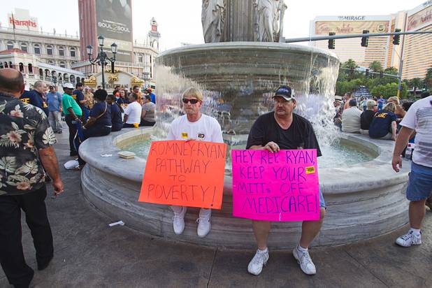 Fran Richardson, left, and Bryan Huffman, of the International Brotherhood of Boilermakers, picket against Republican vice presidential candidate Paul Ryan in front of the Venetian on the Las Vegas Strip Tuesday, Aug. 14, 2012. Ryan was reportedly meeting privately with a small group of supporters at the casino owned by Sheldon Adelson, a billionaire and major donor to Republican campaigns.