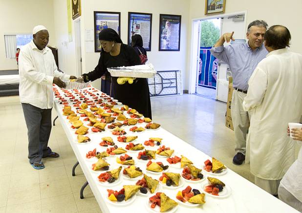 Abdi Muya, left, and Beverly Senior put out dishes for the breaking of the day's fast on the 27th day of Ramadan at the Jamia Masjid mosque Wednesday, Aug. 15, 2012. During the month of Ramadan, Muslims fast from dawn until sunset.