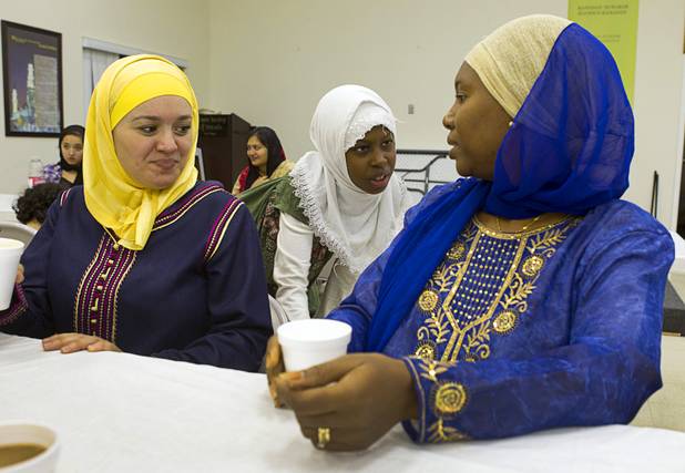 Mariam Diallo, 10, talks with her mother, Fatima, after dinner on the 27th day of Ramadan at the Jamia Masjid mosque Wednesday, Aug. 15, 2012. Jamila Laroussi is at left. During the month of Ramadan, Muslims fast from dawn until sunset.