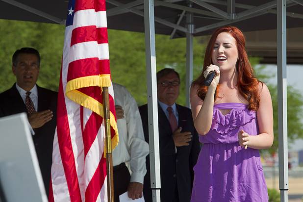 Tenasie Bowe signs the national anthem during a ceremony to celebrate the "grand opening" of the I-15 South Design-Build Project in the Town Square parking lot Wednesday, Aug. 15, 2012. Construction on  $246 million improvement project started in Spring 2010.