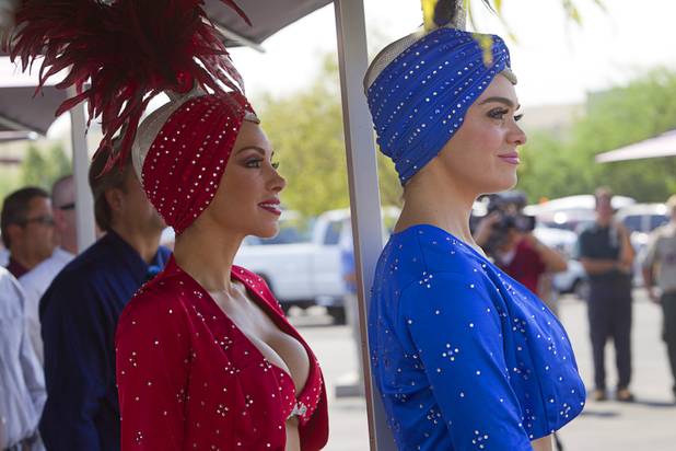 Showgirls Jennifer Johnson, left and Porsha Revesz watch  a ceremony to celebrate the "grand opening" of the I-15 South Design-Build Project in the Town Square parking lot Wednesday, Aug. 15, 2012. Construction on  $246 million improvement project started in Spring 2010.