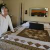 In this file photo taken Thursday, March 20, 2010, in Bolingbrook, Ill., Drew Peterson, who is on trial in the death of his third wife, Kathleen Savio, in 2004, stands in the bedroom of the home from where his fourth wife, Stacy Peterson, disappeared in 2007.