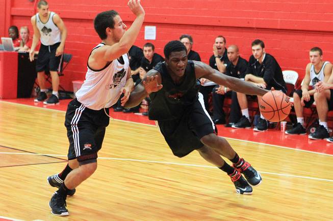 UNLV forward Savon Goodman drives against University of Laval guard Karl Demers-Belanger during their game August 20, 2012 at McGill University in Montreal. The Runnin' Rebels dispatched the Rouge et Or 97-62.