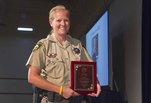 Metro Police Officer Booke Lavin poses with the award for Crisis Intervention Team (CIT) Officer of the Year during a CIT International awards luncheon at the South Point Tuesday, Aug. 21, 2012.  Lavin was honored with the award after calming a suicidal man and then following up to make sure the man received a variety of social services.