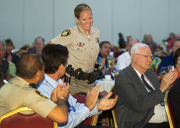 Metro Police Officer Booke Lavin receives applause after being announced as Crisis Intervention Team (CIT) Officer of the Year during a CIT International awards luncheon at the South Point Tuesday, Aug. 21, 2012.  Lavin was honored with the award after calming a suicidal man and then following up to make sure the man received a variety of social services.