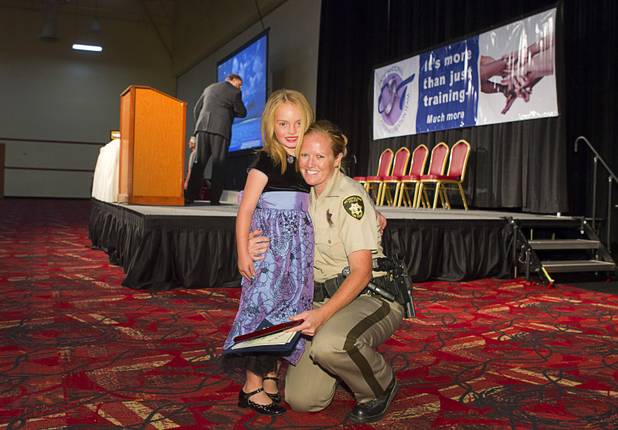 Metro Police Officer Booke Lavin poses with her daughter Justice, 6, after being named Crisis Intervention Team (CIT) Officer of the Year during a CIT International awards luncheon at the South Point Tuesday, Aug. 21, 2012.  Lavin was honored with the award after calming a suicidal man and then following up to make sure the man received a variety of social services.