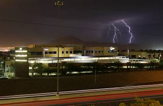 Lightning flashes as a storm passes to the east of the Las Vegas Valley Tuesday, Aug. 21, 2012.