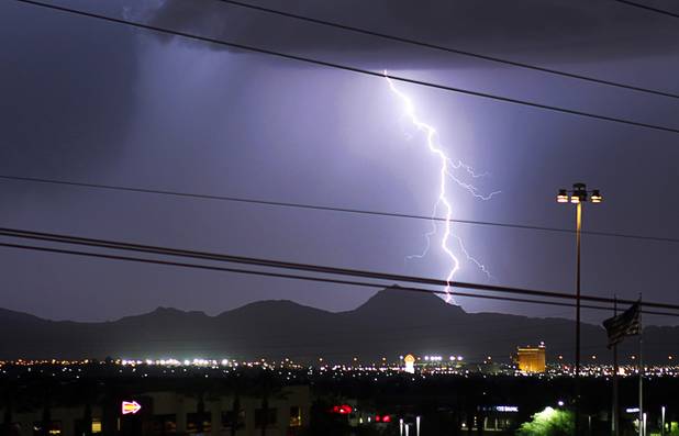 Lightning flashes as a storm passes to the east of the Las Vegas Valley Tuesday, Aug. 21, 2012.