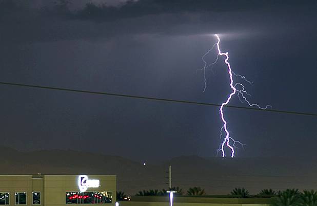 Lightning flashes as a storm passes to the east of the Las Vegas Valley Tuesday, Aug. 21, 2012.