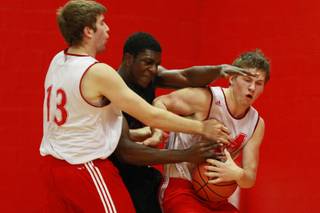 UNLV forward Savon Goodman fights McGill University's Nathan Joyal, left, and Christian McCue for a loose ball during their game Tuesday, August 21, 2012 in Montreal. The Runnin' Rebels beat the Redmen 74-59 to close out their Canada trip at 4-0.