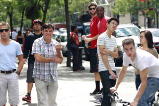 UNLV student manager Vic Armendariz, in cap, and players Carlos Lopez and Demetris Morant wait for teammates to catch up to them on rue Sainte-Catherine in Montreal while taking in the sights before their game against McGill University Tuesday, August 21, 2012.