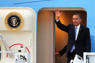 President Barack Obama waves as he departs Air Force One after arriving at Nellis Air Force Base northeast of Las Vegas on Tuesday, August 21, 2012.