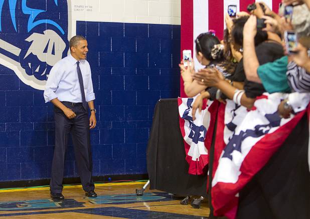 President Barack Obama reacts to supporters as he arrives for a rally at Canyon Springs High School in North Las Vegas Wednesday, Aug. 22, 2012.