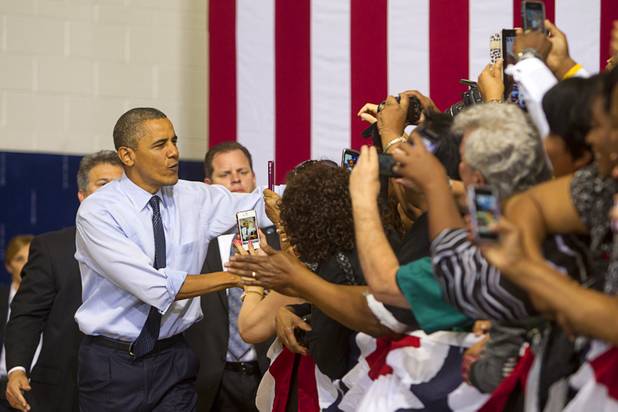 President Barack Obama greets supporters as he arrives for a rally at Canyon Springs High School in North Las Vegas Wednesday, Aug. 22, 2012.