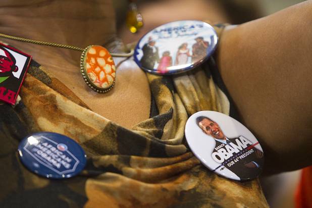 Buttons adorn the blouse of a supporter at President Barack Obama's rally at Canyon Springs High School in North Las Vegas Wednesday, Aug. 22, 2012.