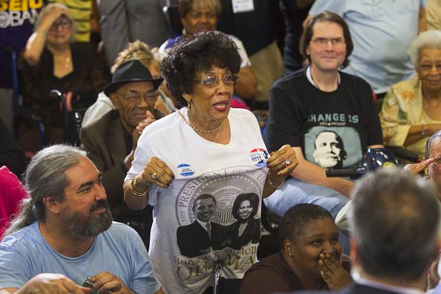 A supporter displays her shirt to President Barack Obama during a rally at Canyon Springs High School in North Las Vegas Wednesday, Aug. 22, 2012.