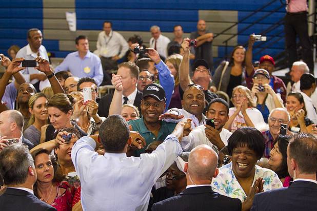 President Barack Obama reaches out to supporters during a rally at Canyon Springs High School in North Las Vegas Wednesday, Aug. 22, 2012.