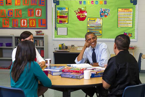 President Barack Obama smiles during a roundtable discussion on K-12 education with Clark County teachers Claritssa Sanchez, foreground left, Lori Elizabeth Henrickson, and Isaac Barron at Canyon Springs High School in North Las Vegas Wednesday, Aug. 22, 2012.