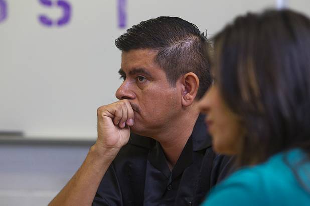 Clark County teachers Isaac Barron and Claritssa Sanchez, listen to President Barack Obama during a roundtable discussion on K-12 education at Canyon Springs High School in North Las Vegas Wednesday, Aug. 22, 2012.