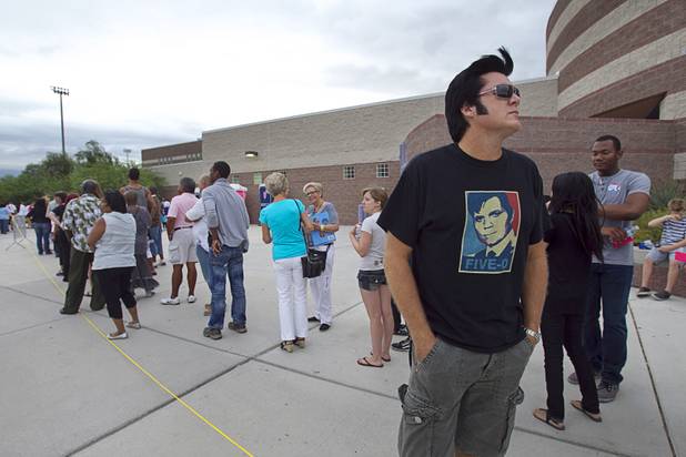 Elvis Presley impersonator Brendan Paul waits in line under cloudy skies to hear President Barack Obama speak at Canyon Springs High School in North Las Vegas Wednesday, Aug. 22, 2012. Paul said he arrived at the school at about 6 a.m. 