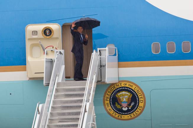 President Obama waves as he boards Air Force One to depart Las Vegas from Nellis Air Force Base, Wednesday, Aug. 22, 2012.