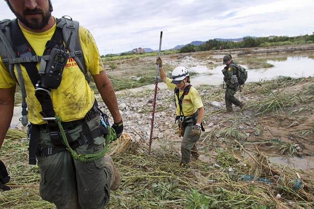 Kylie Grossnicklaus, center, and other volunteers search for Henderson teen William Mootz near the Duck Creek channel, north of Sam Boyd Stadium Thursday, Aug. 23, 2012. Mootz, a Green Valley High School student, was swept away by storm run off in the Pittman Wash Wednesday.