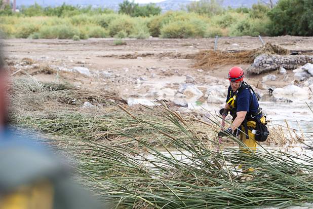 A Henderson firefighter searches for Henderson teen William Mootz near the Duck Creek channel, north of Sam Boyd Stadium Thursday, Aug. 23, 2012. Mootz, a Green Valley High School student was swept away by storm run off in the Pittman Wash Wednesday. Henderson firefighters, Metro Search and Rescue and hundreds of volunteers were searching the area Thursday.