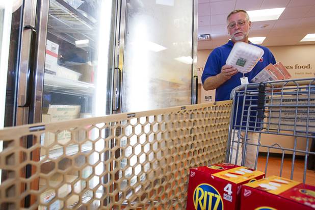 Tony Voggetzer of Sunrise Baptist Church looks over meat at the Agency Store at the Three Square Food Bank Thursday, Aug. 23, 2012. The church's food pantry, which started in a deacon's closet, has already distributed 672,308 lbs. of food this year, according to Three Square records.