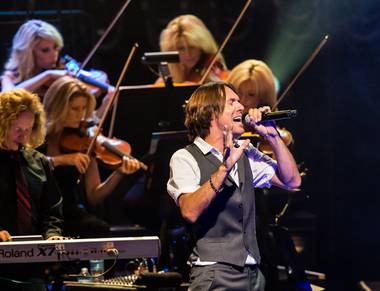 Brody Dolyniuk sings in “The Symphonic Rock Show,” which features a band and 25 orchestral musicians, at Reynolds Hall in the Smith Center for the Performing Arts on Friday, Aug. 24, 2012.