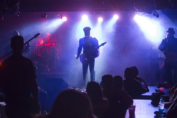 Prince impersonator Jason Tenner performs in his show Purple Reign ...