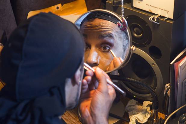 Prince impersonator Jason Tenner applies make-up at home before heading ...