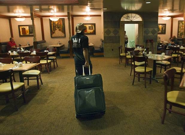 Prince impersonator Jason Tenner heads through a restaurant to get ...