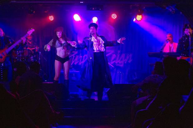 Prince impersonator Jason Tenner, center, performs in The D showroom in downtown Las Vegas Sunday, Aug. 26, 2012.