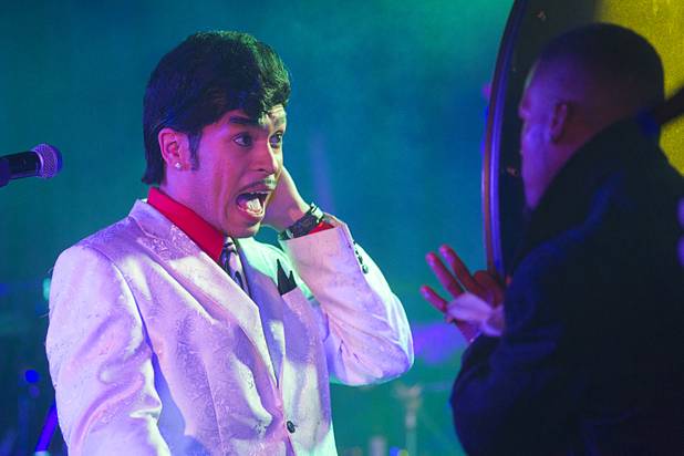 Drew James (as Morris Day) looks at his image in a mirror held by Thomas Austin (impersonating  Jerome Benton) in The D showroom in downtown Las Vegas Sunday, Aug. 26, 2012. Day and Benton were members of The Time, one of the most famous of the Prince associated bands. The band released four albums between 1981 and 1990, with Prince writing and performing most of the instrumentation and backing vocals, with lead vocals by Morris Day.