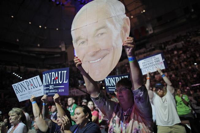 Mary White of Rathdrum, Idaho, shows her support for Rep. Ron Paul, R-Texas, at a rally at the University of South Florida Sun Dome on the sidelines of the Republican National Convention in Tampa, Fla., on Sunday, Aug. 26, 2012.