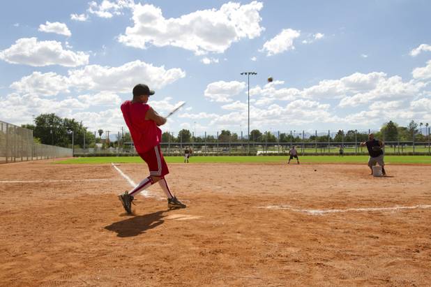 Raul Tehandon plays softball with members of the Potter's House Christian Fellowship at a Lorenzi Park ball field Sunday, Aug. 26, 2012. STEVE MARCUS