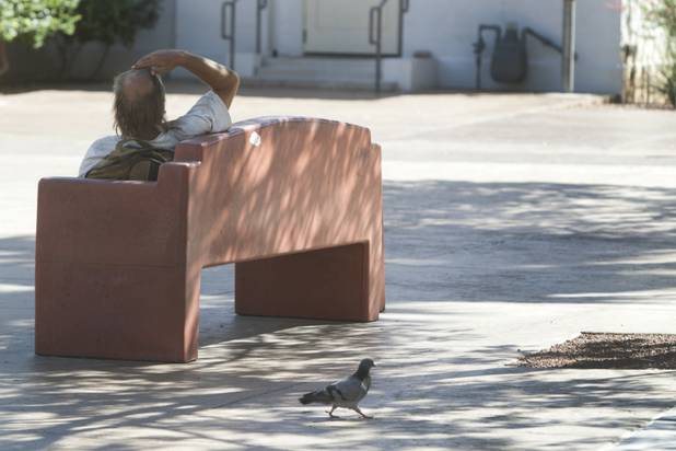 A man rests on a bench at Centennial Plaza in downtown Las Vegas Sunday, Aug. 26, 2012. STEVE MARCUS
