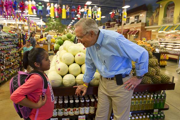 Senate Majority Leader Harry Reid talks with second grader Noemi Ramirez while touring Cardenas  Market at Meadows Lane and Decatur Boulevard Monday, Aug. 27, 2012.