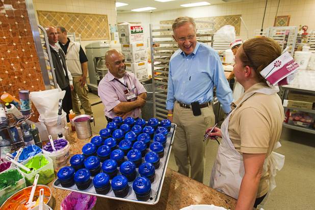Senate Majority Leader Harry Reid talks with bakery worker Luz Cruz while touring the Cardenas  Market at Meadows Lane and Decatur Boulevard Monday, Aug. 27, 2012. Cardenas district manager Manny Garcia looks on at left,