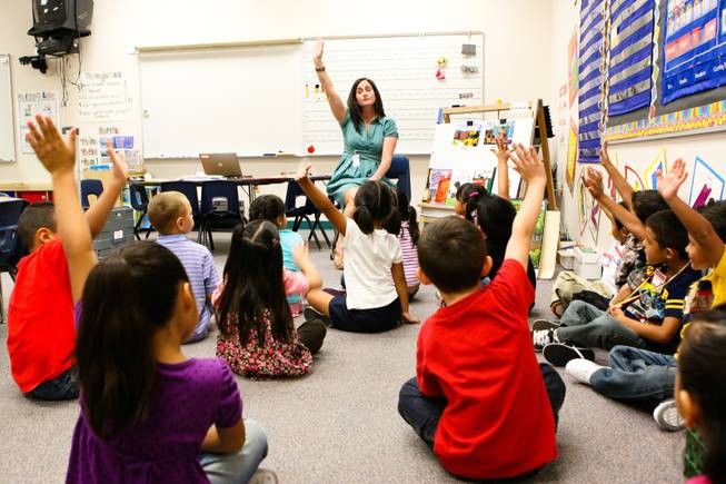 Kindergarten teacher Julie Cohen teaches her students how to ask questions with a raise of hands on their first day of class Monday, August 27, 2012, at Cambeiro Elementary School in Las Vegas.