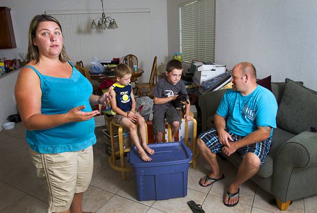 UNLV graduate student Rebecca Lovelady, talks about the theft of her moving van during an interview at her home Tuesday, Aug. 28, 2012. The family lost nearly all their possessions when their moving truck was stolen earlier this month but the Las Vegas community helped out with donated furniture, goods and a fundraiser after their story was broadcast on KNTV-Channel 13 news, she said. In the background are her sons her experience her sons Preston, 5, and Theirry, 7, and boyfriend Rob Williams.