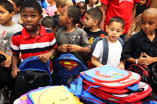 Students from Whitney Elementary School grab free backpacks donated by Station Casinos at the school on Wednesday, August 29, 2012. The donation was part of Station Casinos "Smart Start" school sponsorship program to assist high need elementary schools in the Las Vegas Valley.