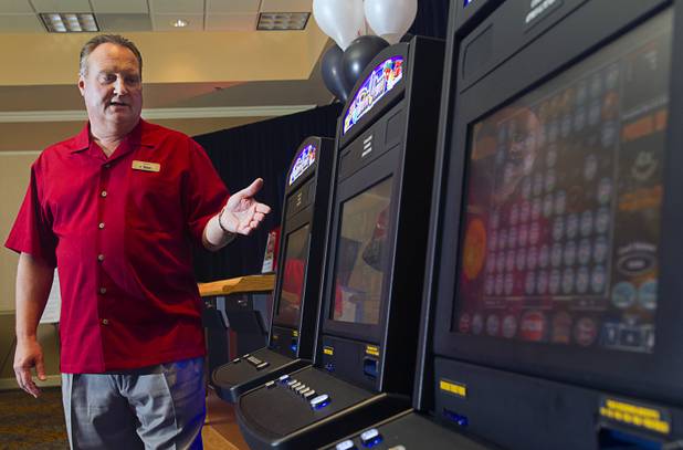 Steve Arntzen, president/CEO of United Coin Machine Company, shows off new games during a news conference at the Orleans Wednesday, Aug. 29, 2012. United Coin, one of the state's largest independent route operators, unveiled five new products for slot route operators.