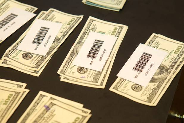 Cash is displayed during a United Coin Machine Company news conference at the Orleans Wednesday, Aug. 29, 2012. United Coin, one of the state's largest independent route operators, unveiled SmoothPay, a program to guarantee location owners a minimum payment amount of at least 90 percent of their average share each week.