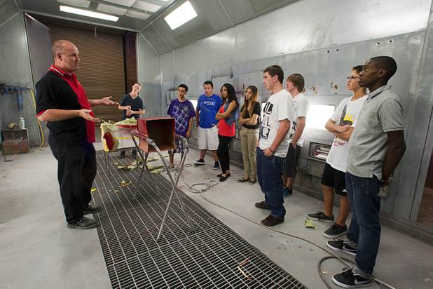 Teacher Scott Fitzgerald talks to students in a paint booth during an Introduction to Auto Collision Repair class at the Southeast Career and Technical Academy in Henderson, Wednesday, Aug. 29, 2012.