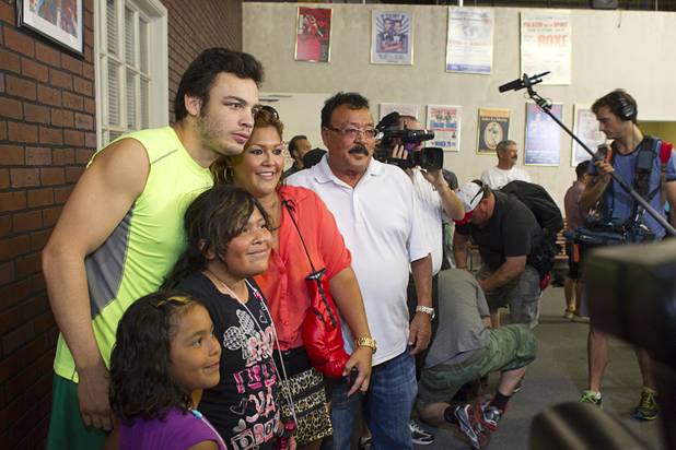 WBC middleweight champion Julio Cesar Chavez Jr., son of boxing legend Julio Cesar Chavez, poses with boxing fans before interviews at Top Rank Gym Thursday, Aug. 30, 2012, Chavez will defend his title against Sergio Martinez of Argentina at the Thomas & Mack Center Sept. 15.