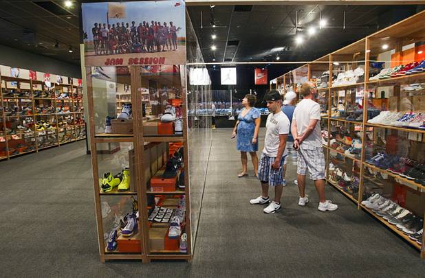 People look over displays of Nike shoes during the grand opening of the ShoeZeum at the Neonopolis mall in downtown Las Vegas Thursday, Aug. 30, 2012. The collection has 2,500 pairs of new Nike shoes.