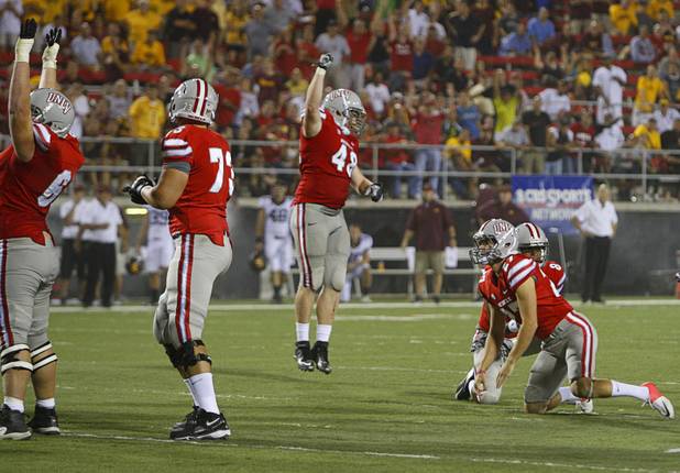 UNLV players celebrate a field goal by Nolan Kohorst, right, that tied the game 13-13 during UNLV's season opener against Minnesota at Sam Boyd Stadium on Thursday, Aug. 30, 2012.