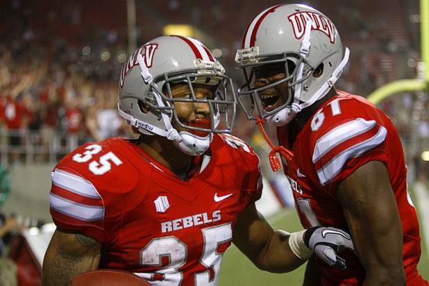 UNLV's Tim Cornett, left, celebrates with Devante Davis after scoring in the first overtime period against Minnesota at Sam Boyd Stadium Thursday, Aug. 30, 2012.