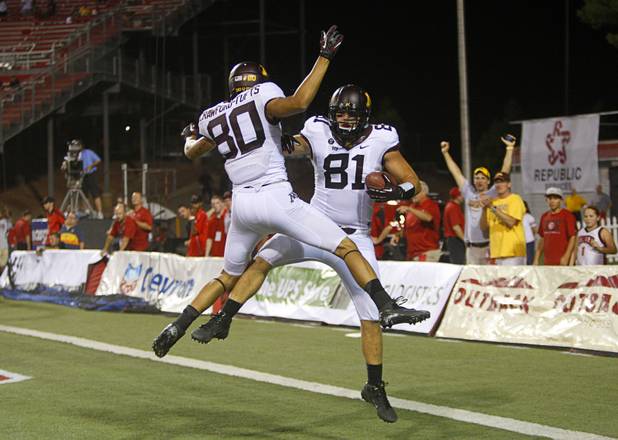 Minnesota's John Rage, right, celebrates with teammate Devin Crawford-Tufts after scoring in the second overtime period during UNLV's season opener at Sam Boyd Stadium Thursday, Aug. 30, 2012.